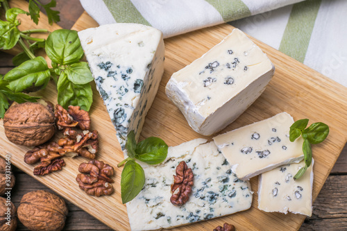 Fourme d'ambert blue cheese  and walnuts. Wooden background. Top view photo