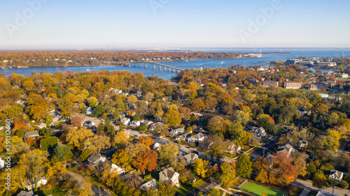 Aerial view of colorful sailboat moorings, docks,   and bright golden foliage on Weems Creek, in historic downtown Annapolis Maryland on a fall day photo