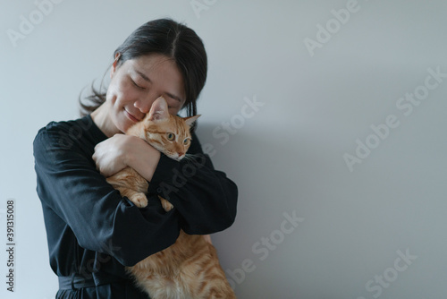 happy woman hugging her cat