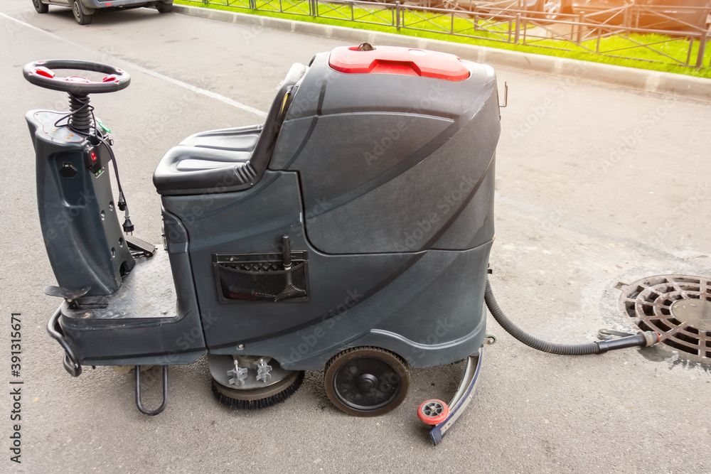 Floor care and cleaning services with professional washing machine the outside of the building drains dirty water. Floor care and cleaning services with professional washing machine the outside of the building drains dirty water.