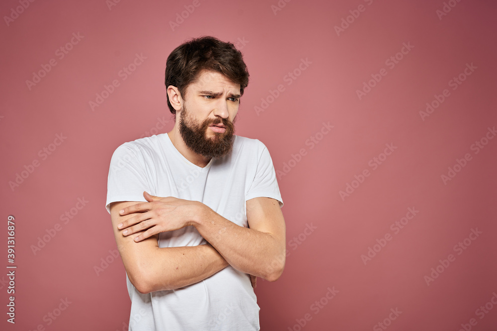Man in white t-shirt emotions lifestyle facial expression cropped view pink background. Man in white t-shirt emotions lifestyle facial expression cropped view pink background.