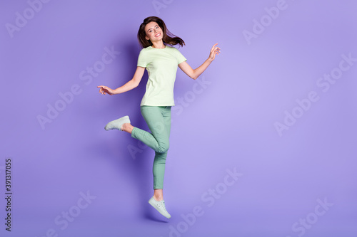 Fototapeta Naklejka Na Ścianę i Meble -  Photo portrait full body view of cute woman jumping up isolated on vivid purple colored background