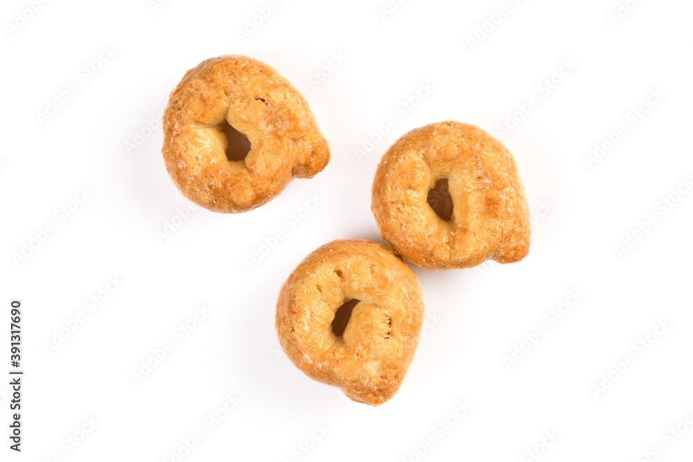 Taralli or tarallini, traditional italin snack from wheat dough. Three pieces close-up isolated on white background.