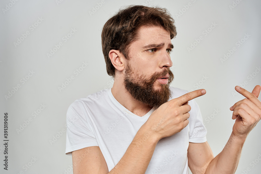 Bearded man gesturing with hand white cropped t-shirt studio lifestyle Bearded man gesturing with hand white cropped t-shirt studio lifestyle