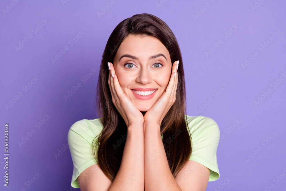 Photo portrait of cute girl touching cheeks with both hands smiling isolated on bright purple color background Photo portrait of cute girl touching cheeks with both hands smiling isolated on bright purple color background