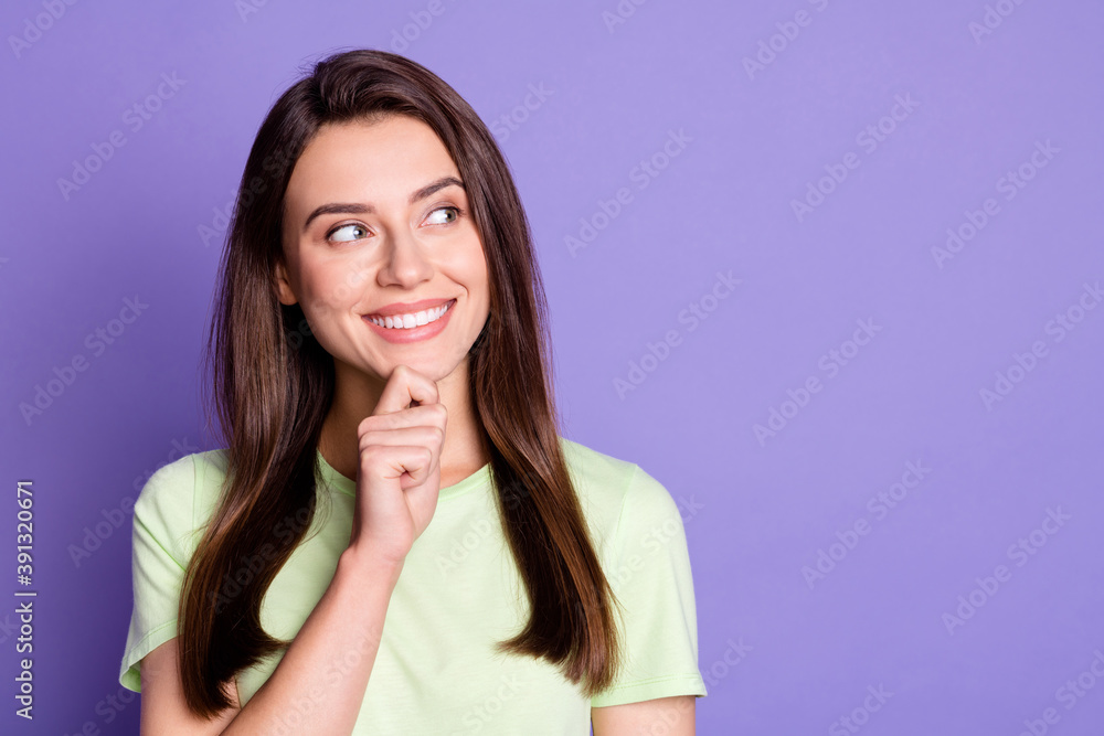 Portrait of funky young girl smile looking empty space arm on chin isolated on vivid purple color background Portrait of funky young girl smile looking empty space arm on chin isolated on vivid purple color background