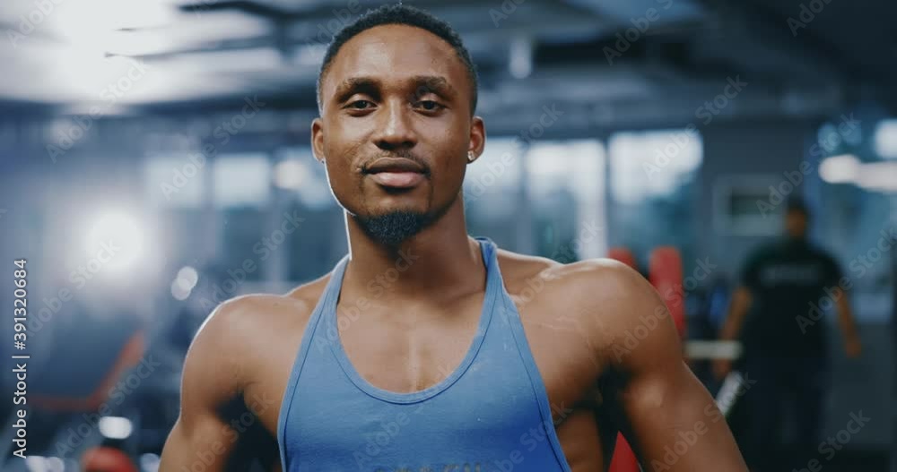 Handsome muscular afro-american sportsman posing in the gym after training session practice. Active people lifestyle. Bodybuilder portrait. Ethnicity. Healthcare concept. Handsome muscular afro-american sportsman posing in the gym after training session practice. Active people lifestyle. Bodybuilder portrait. Ethnicity. Healthcare concept.