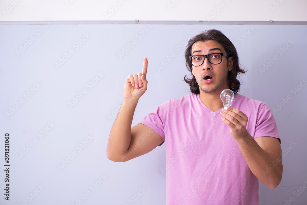Young male student in front of board Young male student in front of board