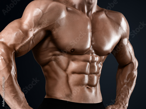 Male abdominal muscles, Bodybuilder shows abs, Dark background