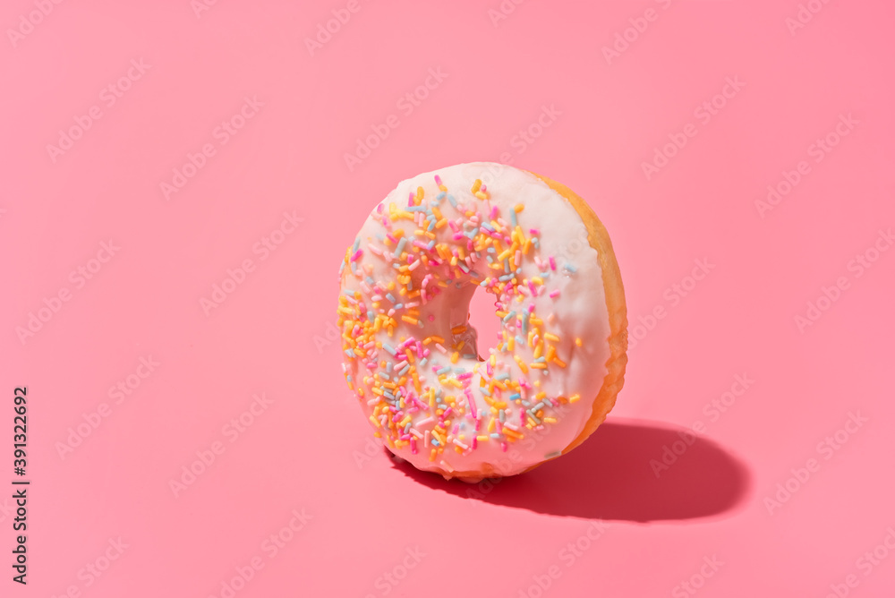 Trendy sunlight doughnut on bright light pink background. Minimal summer concept