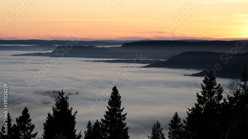 The fog is dense and like a lid on top of Oslo  Norway. Clear sky above the fog and it almost loos like clouds. Shot in golden hour and blue hour to get the best light. Shot from Holmenkollen. 