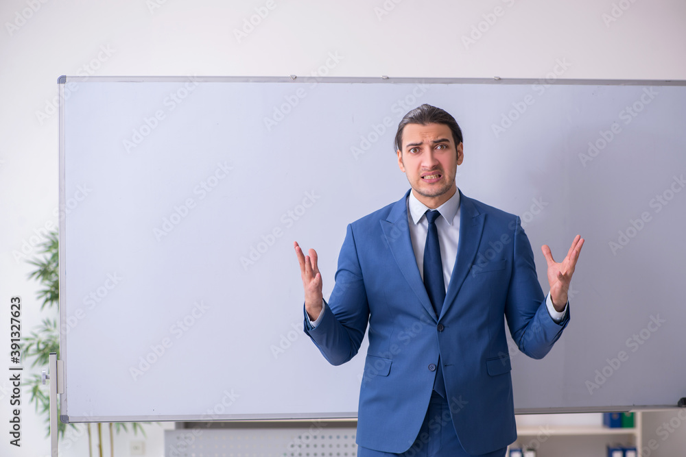 Young man employee in business presentation concept Young man employee in business presentation concept