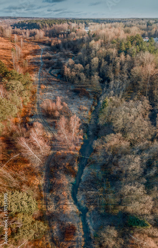 Aerial view of small forest river Skalba in Moscow region, Russia. Beautiful autumn landscape at sunny november day