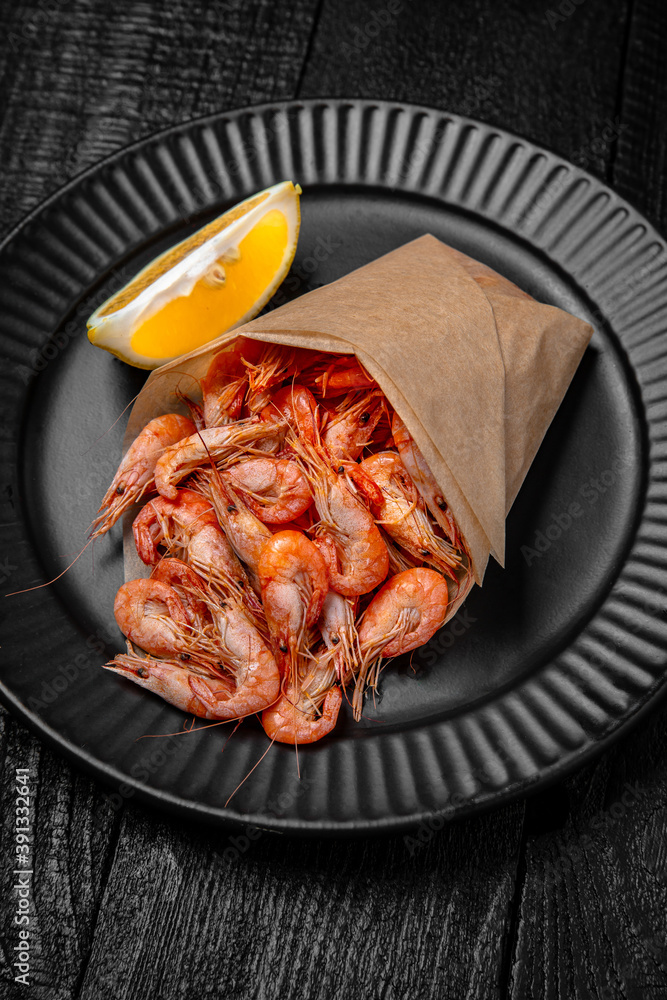 Small shrimps boiled with salt and spices. Beer snack. Festive table with delicious food. Small shrimps boiled with salt and spices. Beer snack. Festive table with delicious food.