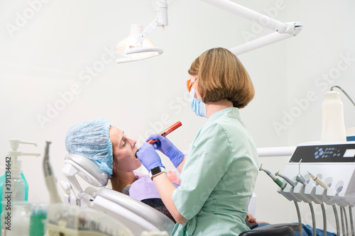 Dental office. Dentist treats teeth to a girl.