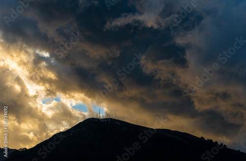 Dramatic rain clouds above the Pichincha volcano at sunset with the arrival of the rainy season in Quito, Andes mountains, Ecuador.