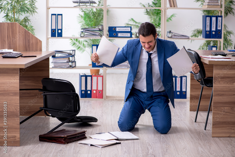 Young male employee businessman at workplace Young male employee businessman at workplace