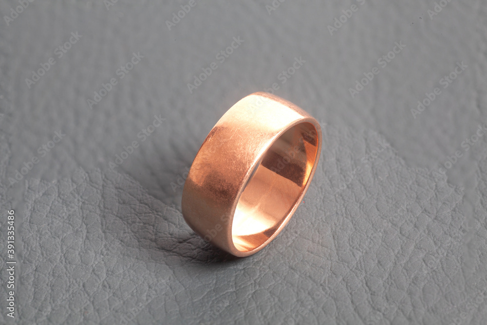 Golden wedding ring on gray background Golden wedding ring on gray background