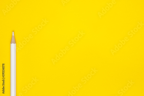 Horizontal white sharp wooden pencil on a bright yellow background, isolated, copy space, mock up.