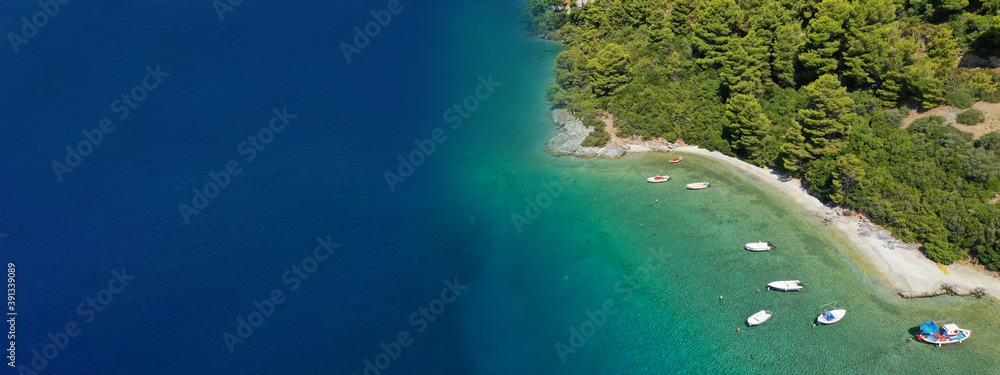 Aerial ultra wide panoramic view of tropical paradise rocky bay visited by sailboats and yachts in Caribbean exotic destination island