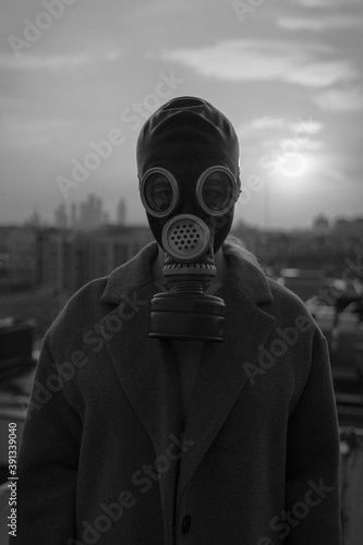 
man in a gas mask on the background of a big city