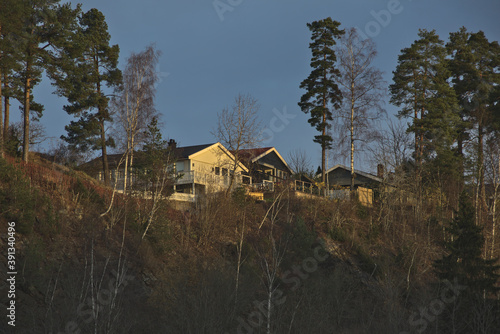 Wooden houses on the hill in the sunset far distance