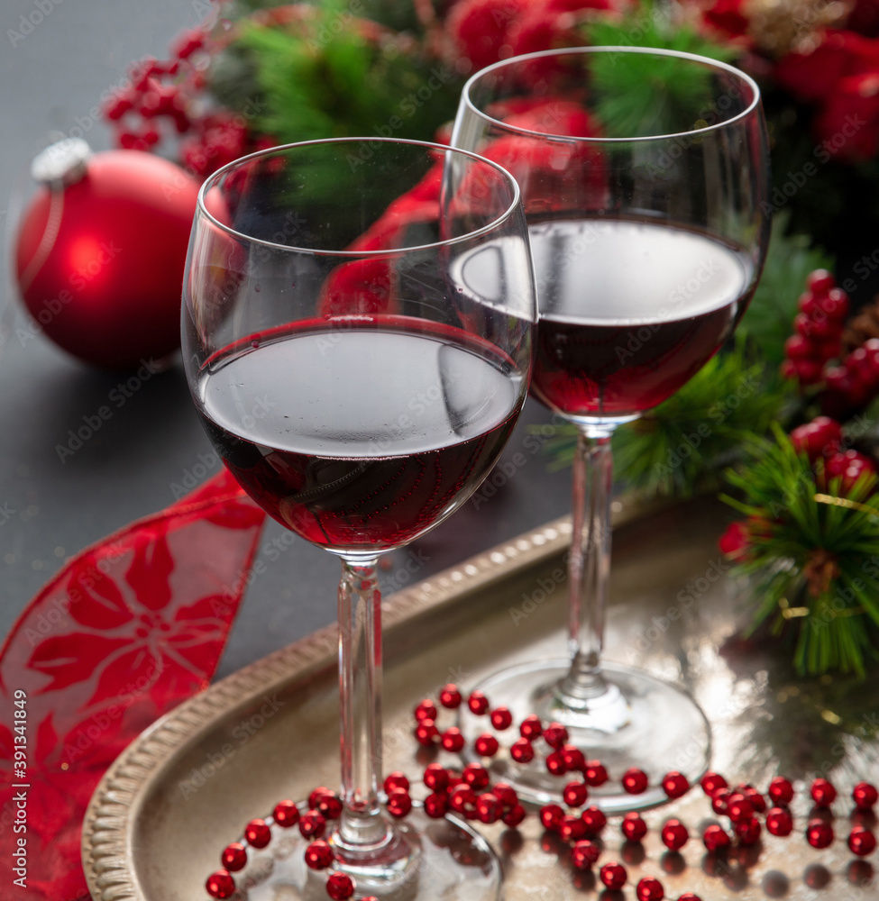 Christmas red wine glasses and xmas decoration on the table, closeup view Christmas red wine glasses and xmas decoration on the table, closeup view
