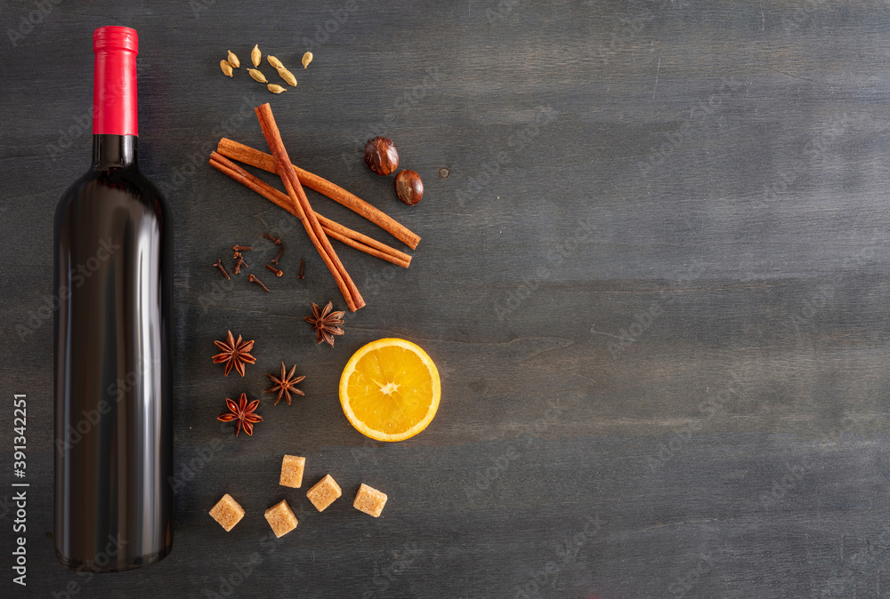 Mulled wine recipe ingredients, Christmas hot drink. Orange, cinnamon sticks, star anise, nutmeg, cloves and sugar on blue wood Mulled wine recipe ingredients, Christmas hot drink. Orange, cinnamon sticks, star anise, nutmeg, cloves and sugar on blue wood