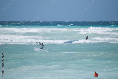
evolutions with kitesurfing on a rough blue sea