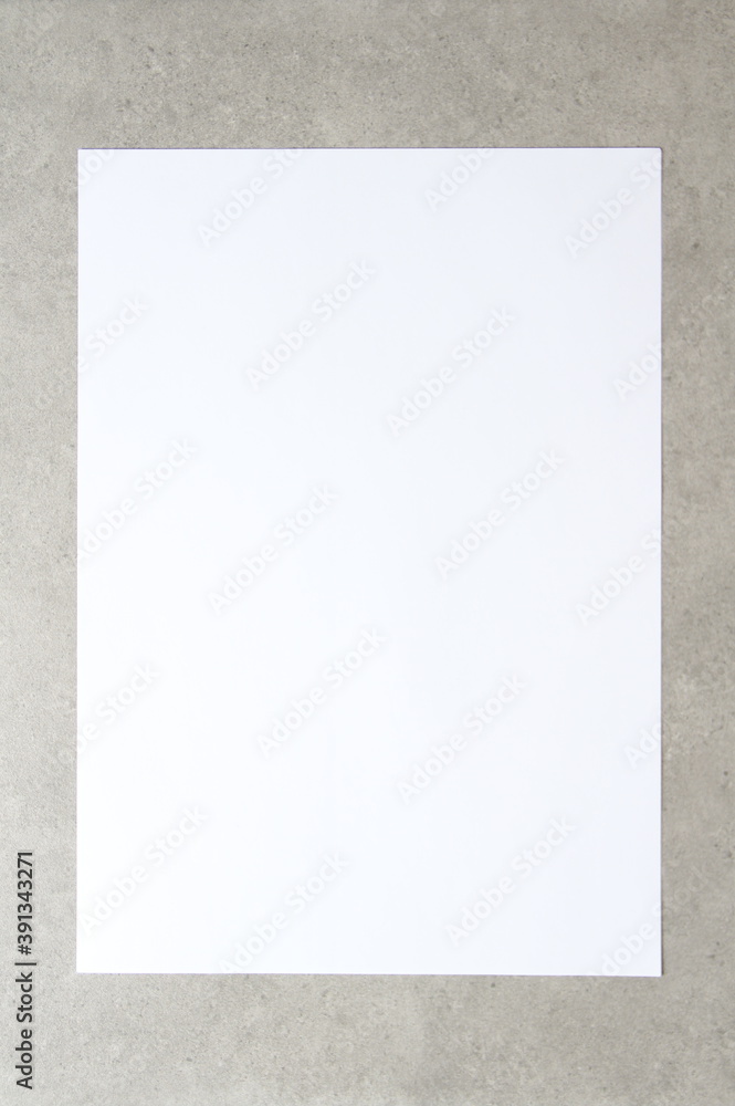 Template of white paper on light grey concrete background. Concept of new idea, business plan and strategy, development and implementation of content. Stock photo with empty space for text Template of white paper on light grey concrete background. Concept of new idea, business plan and strategy, development and implementation of content. Stock photo with empty space for text