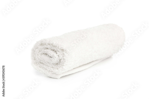 one white new towel rolled up on a white background