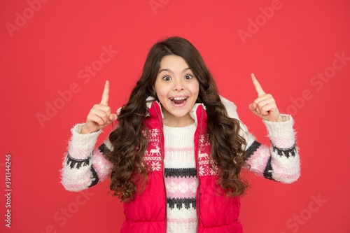 inspired child with long curly hair in christmas aparrel. cold season activity style. childhood happiness. thermal clothing. happy teen girl wear warm clothes. winter kid fashion. great idea photo