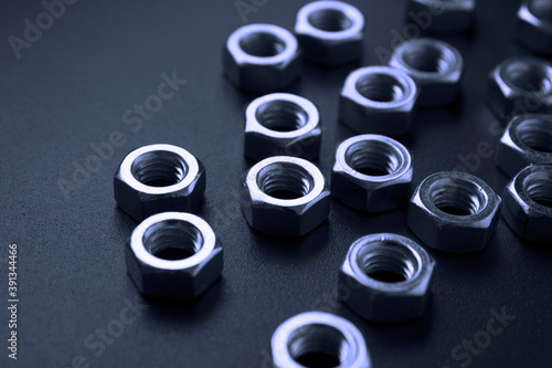 screw-nuts on a dark surface