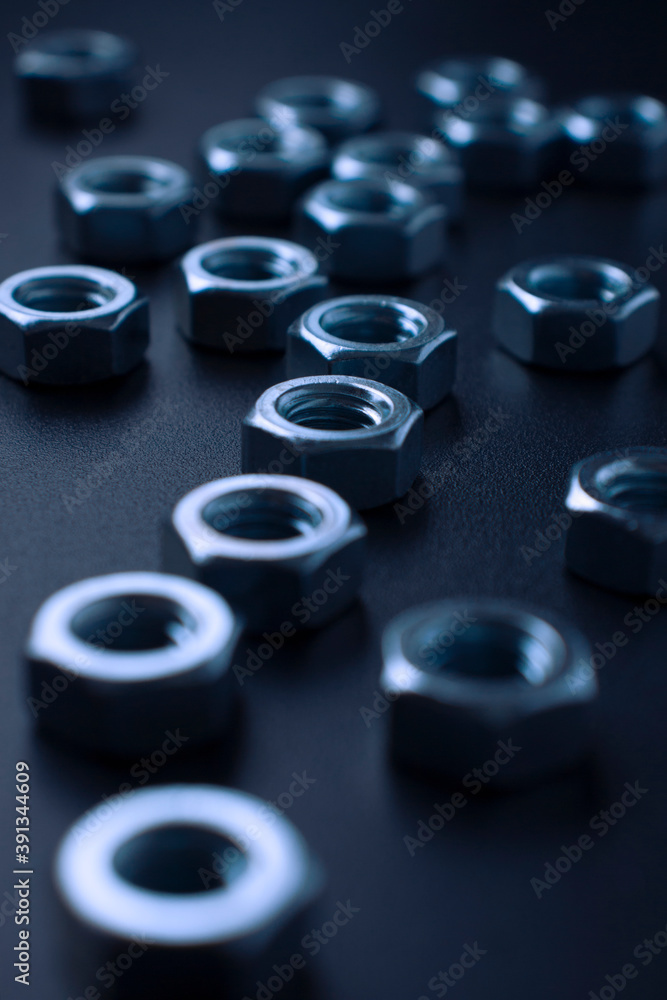 screw-nuts on a dark surface screw-nuts on a dark surface