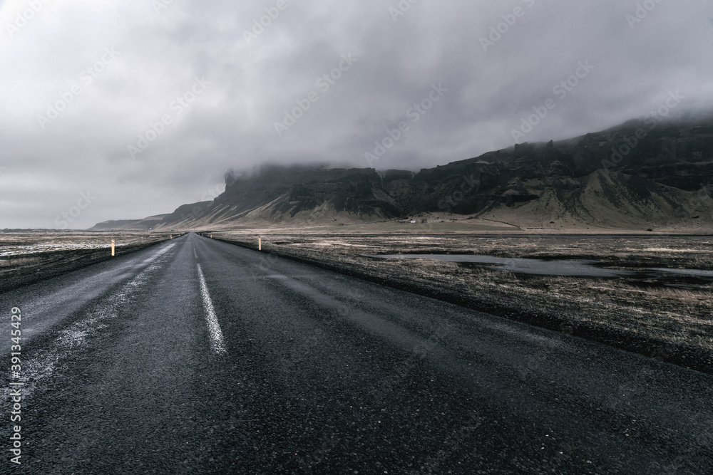 Dramatic storm clouds over empty road near Skeiðarársandur