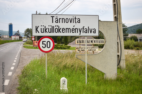 Place name sign of the village of Târnovița, Romania. Hungarian name is Küküllőkeményfalva and is difficult to pronounce for foreigners photo