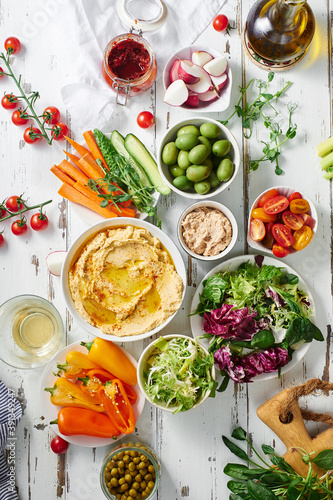 Hummus dip and fresh vegetarian snacks photo