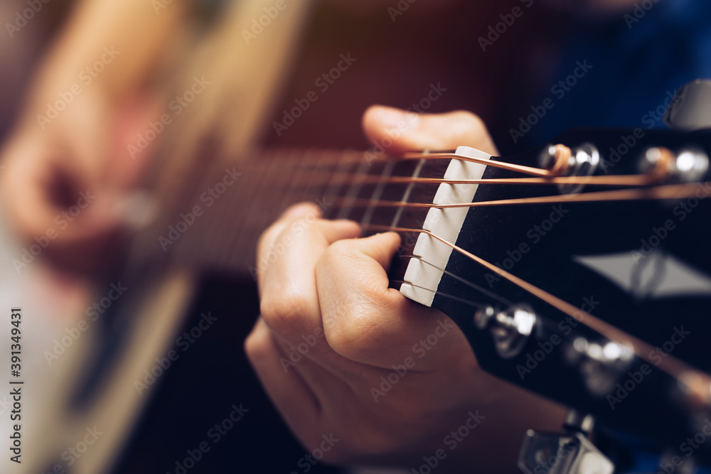 Close-up hands and tuning of the guitar player