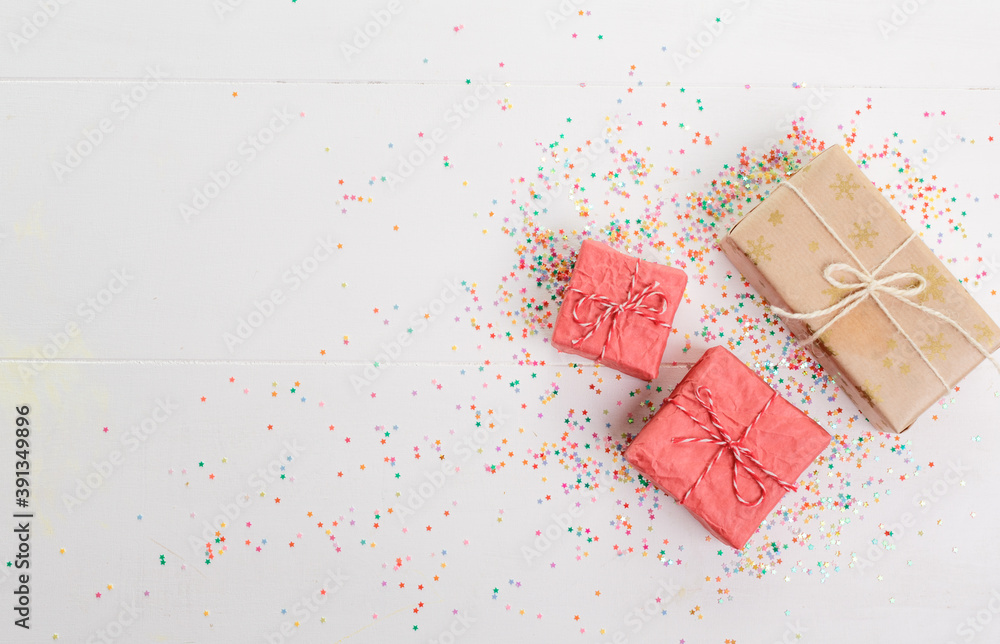 Lots of Christmas gifts in big and small boxes, confetti scattered around on a white isolated background Lots of Christmas gifts in big and small boxes, confetti scattered around on a white isolated background