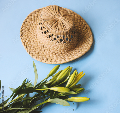 summer hat on background with yellow tulips photo