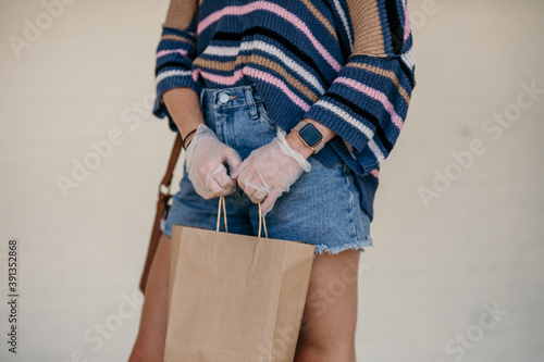 Girl shopping with mask and gloves during covid 19 corona virus crisis