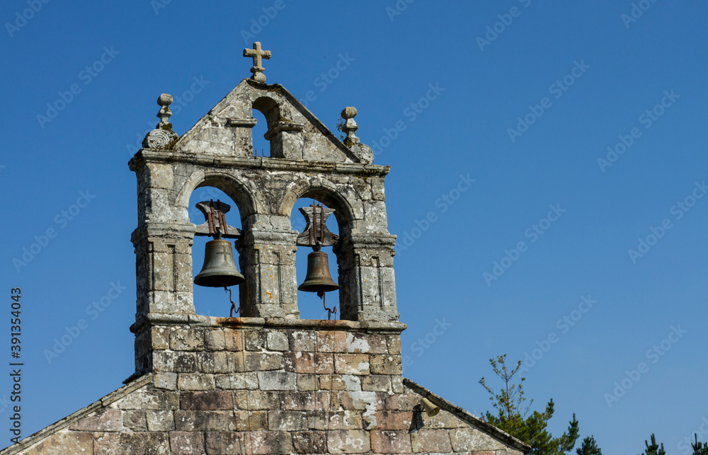 Bells in abandoned church with a beautiful blue sky
