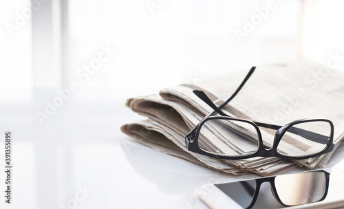 glasses on a daily newspaper.