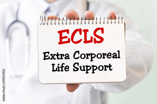 Doctor holding a card with text ECLS - Extra Corporeal Life Support - medical concept photo