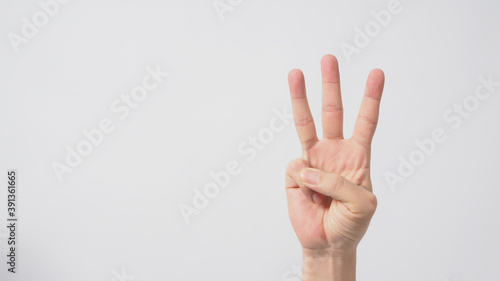 A hand sign of 3 fingers point upward meaning three or third.It put on white background