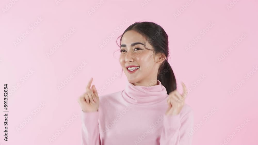 Beauty concept. Asian girl is dancing cheerfully on a pink background. 4k Resolution. Beauty concept. Asian girl is dancing cheerfully on a pink background. 4k Resolution.