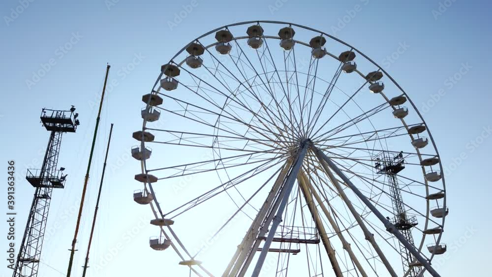 Layout or template for video editing. Moving towards ferris wheel on a background of blue sky. Stabilized with gimbal Layout or template for video editing. Moving towards ferris wheel on a background of blue sky. Stabilized with gimbal