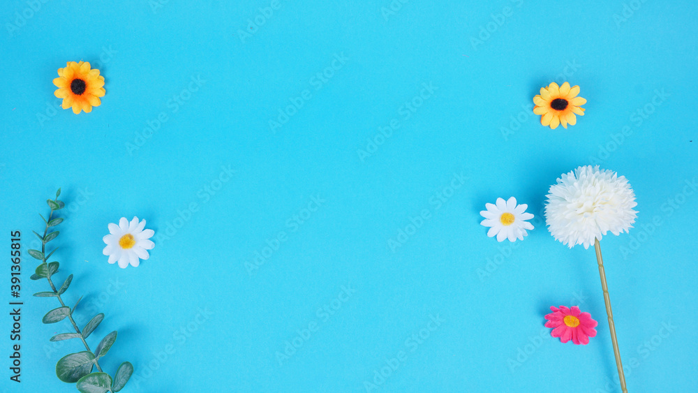 Beautiful frame of flowers on a blue background, free space for the text