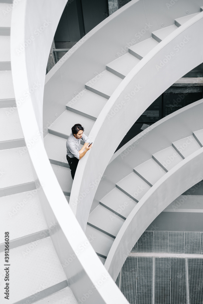 Businessman Using Smartphone On Stairs