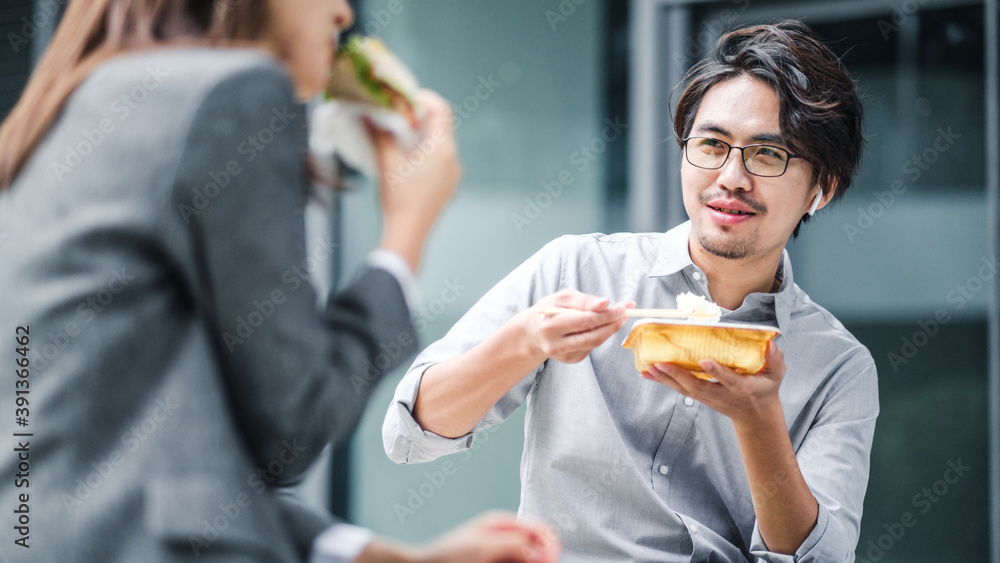 Businessman And Businesswoman Eating Lunch Together Businessman And Businesswoman Eating Lunch Together